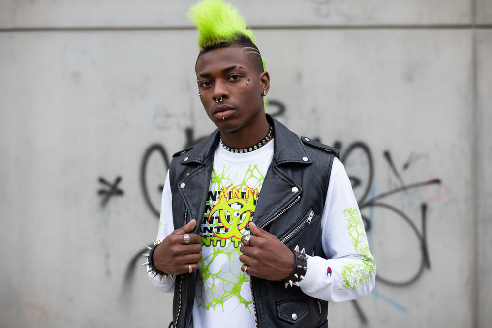 White long sleeve men's Champion shirt with green abstract web design, biohazard symbol, and "Anti Toxic" text on front and sleeves