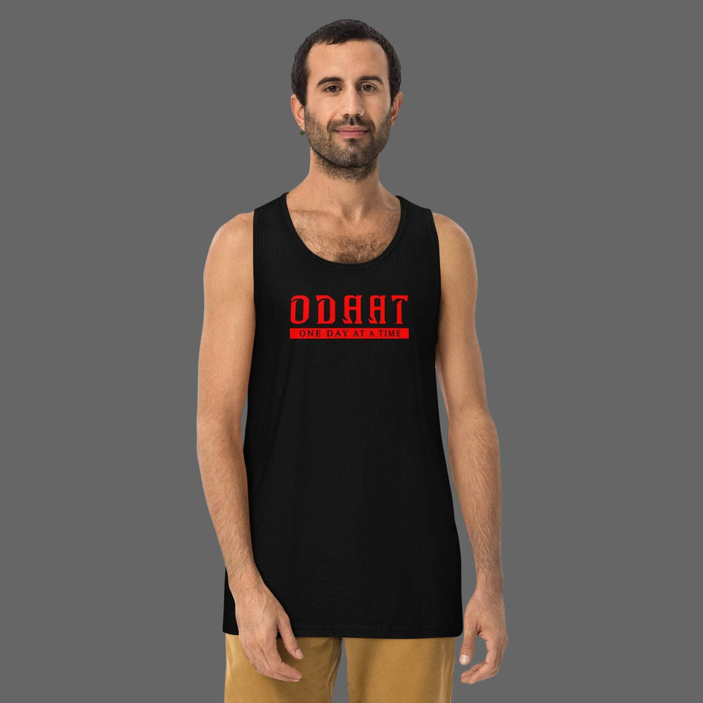 Men’s premium black tank top with red ODAAT logo worn by a man in casual pose