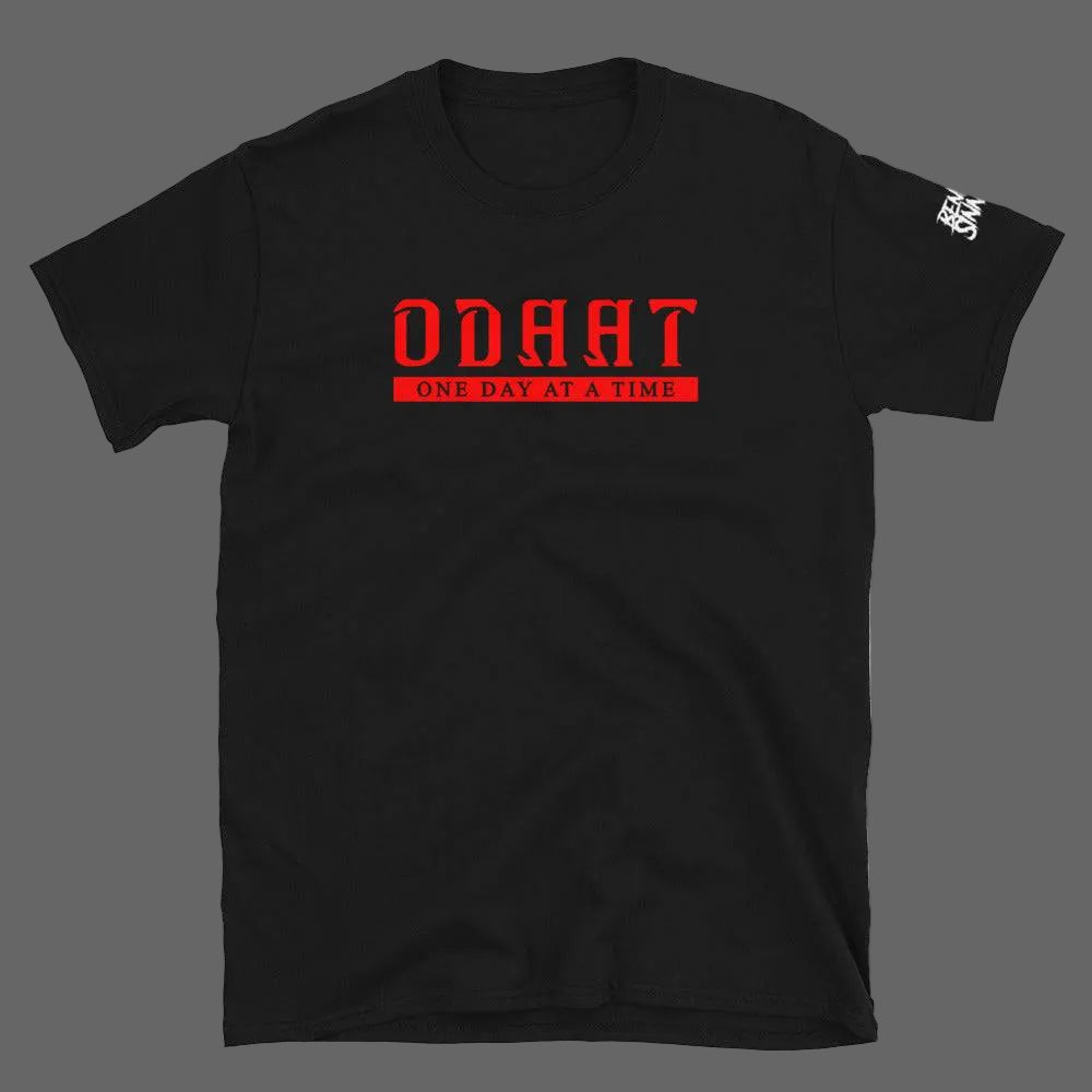 Black unisex short-sleeve t-shirt with red "ODAAT One Day At A Time" text, made of soft 100% ring-spun cotton, casual recovery lifestyle wear.